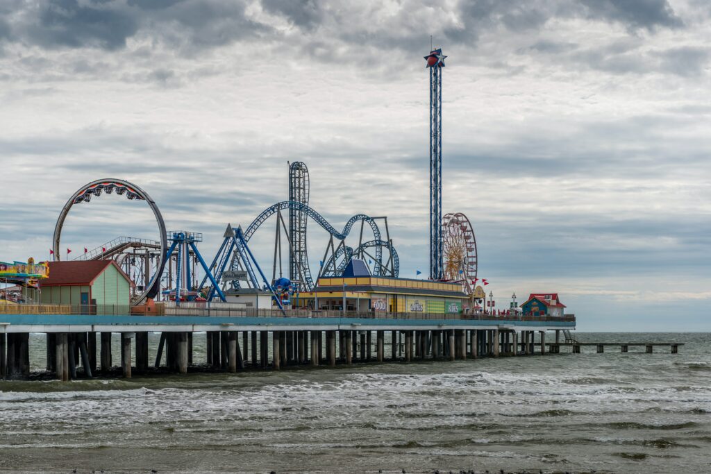 blue and white ferris wheel near body of water during daytime