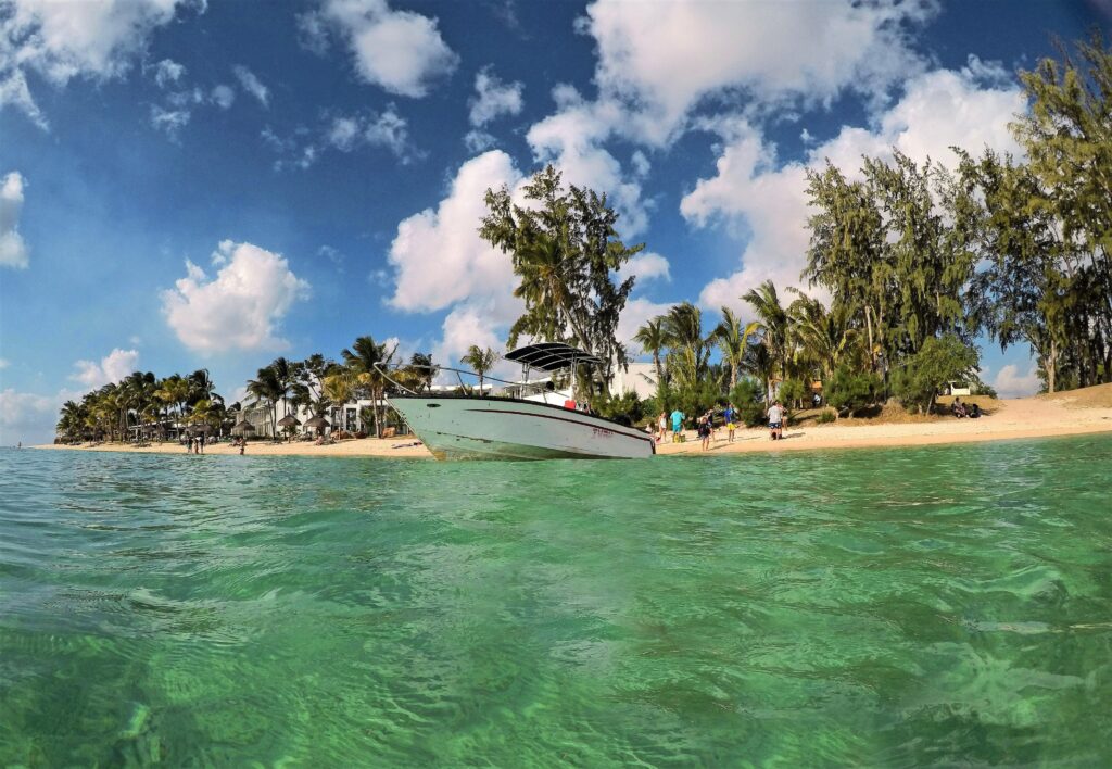 low-angle photography of powerboat near shore