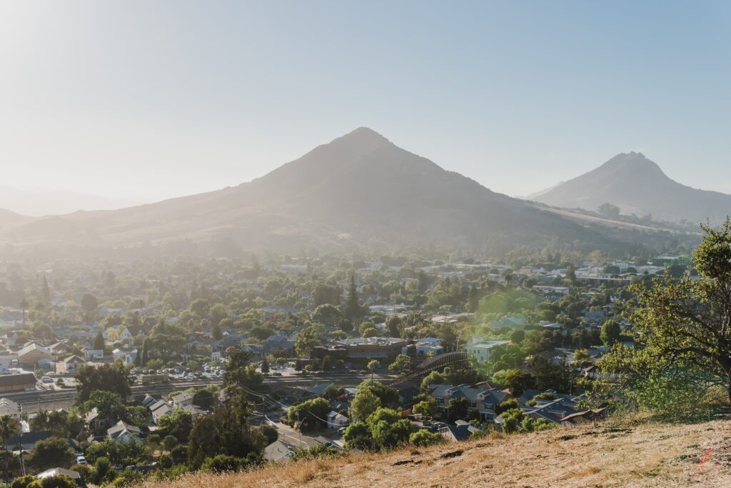 photo of madonna mountain and cityscape during day time 